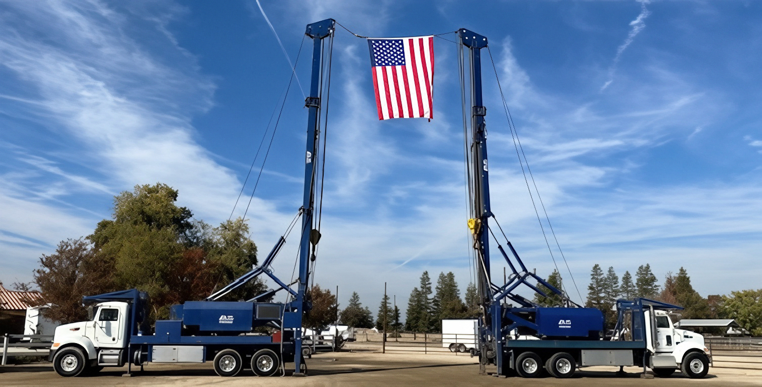 Farm Pump & Irrigation well drilling rigs with an American flag at the company's Shafter, CA yard